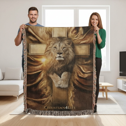 Two people holding a blanket with a lion and cross design in a living room.