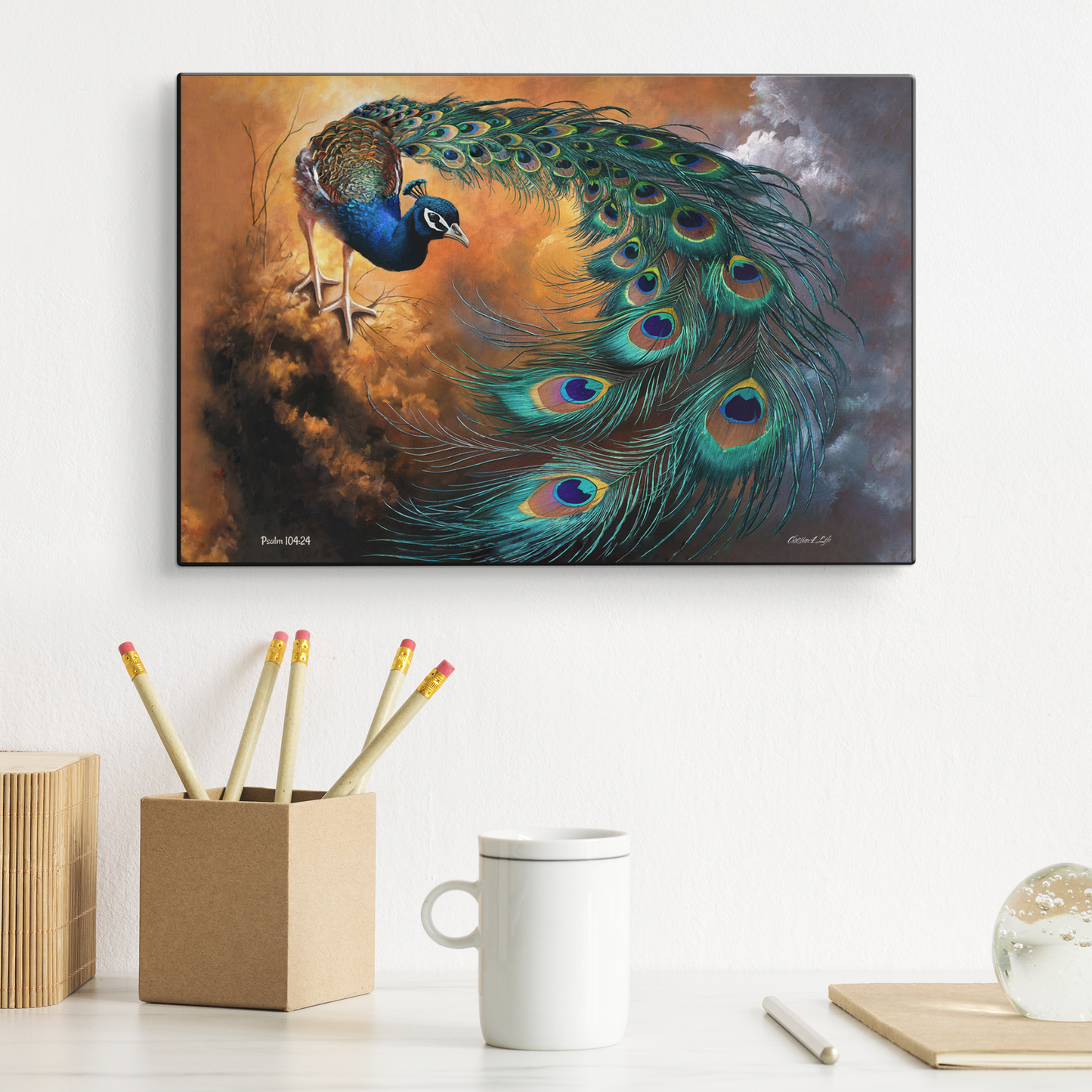 Peacock painting on a wall above a desk with stationery items.