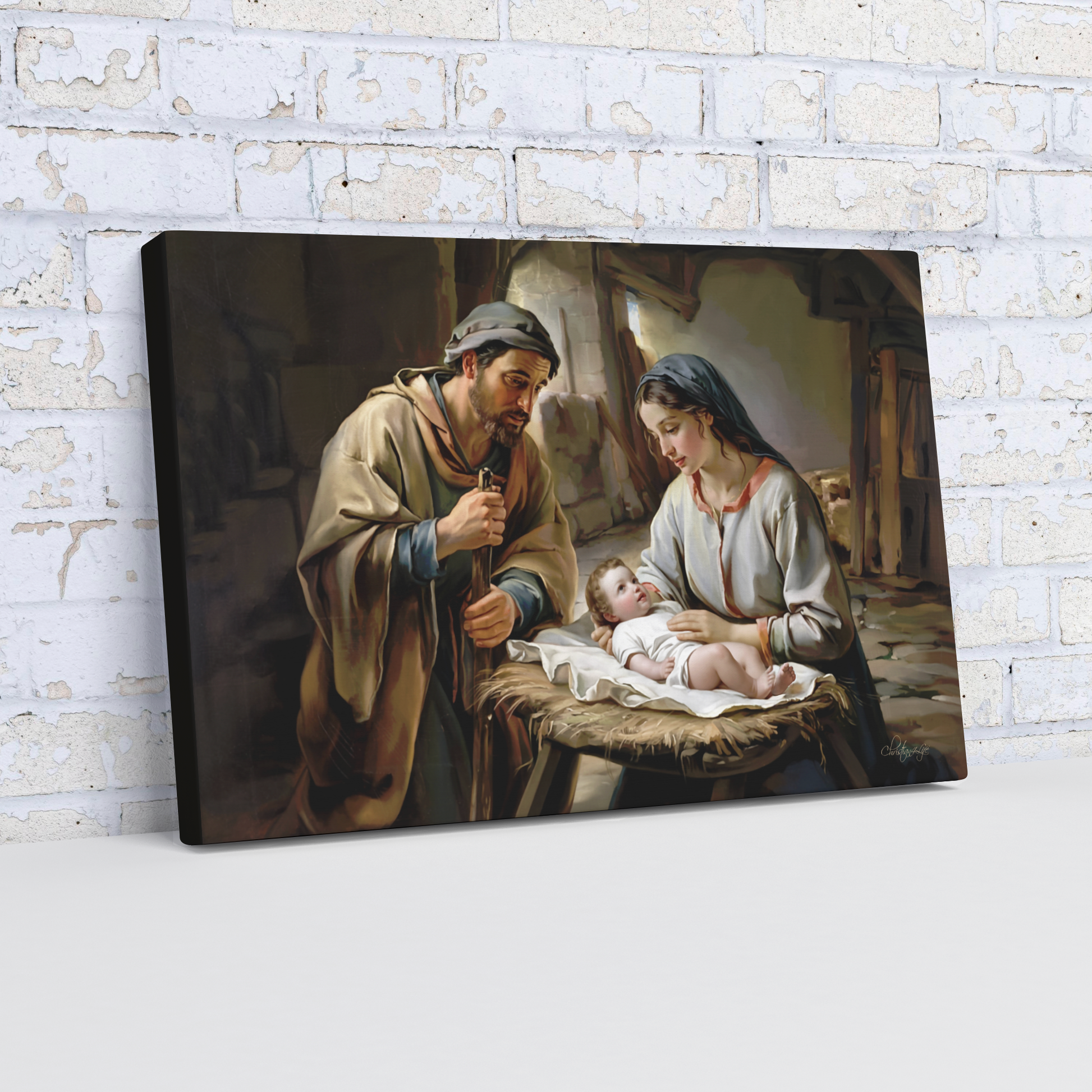 Painting of baby Jesus, Joseph and Mary  against a brick wall.