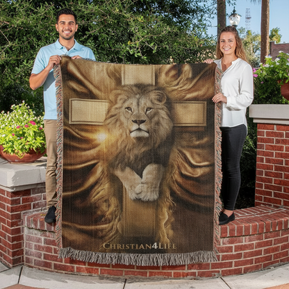 Two people holding a blanket with a lion and cross design and 'Christian4Life' text outdoors.