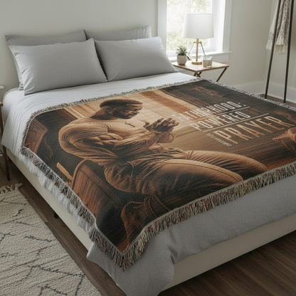 Bed with a decorative blanket featuring an artistic design on a neutral-toned room.