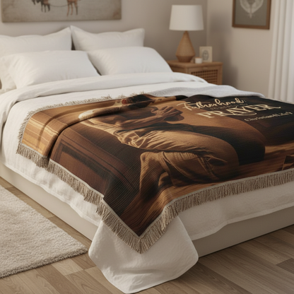 Brown blanket with text draped over a bed in a bedroom setting