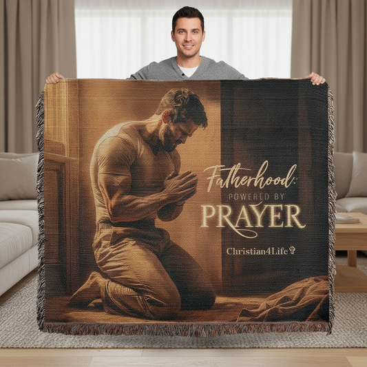 Man holding a blanket with a praying man design and text in a living room.