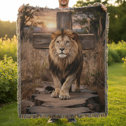 Person holding a blanket with a lion design outdoors