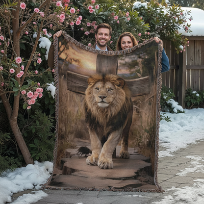 Two people holding a blanket with a lion design outdoors in winter.